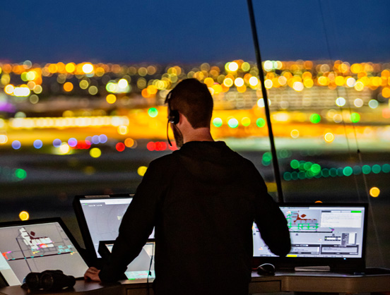 Melbourne air traffic controller in Air Traffic Control Tower at night-time.