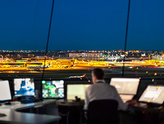 Melbourne air traffic controller in Air Traffic Control Tower at night-time.