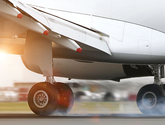 Aeroplane landing on tarmac.