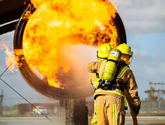 Aviation rescue fire fighters putting out a fire.