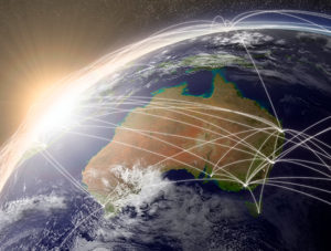 Flight paths in and out of Australia on the map of the world.