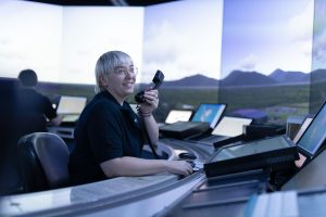 A woman air traffic controller sits in a Brisbane Air Traffic Tower SIM