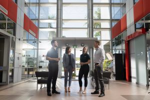 Airservices Australia employees chatting in an office lobby