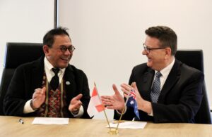 Two men sign a joint agreement