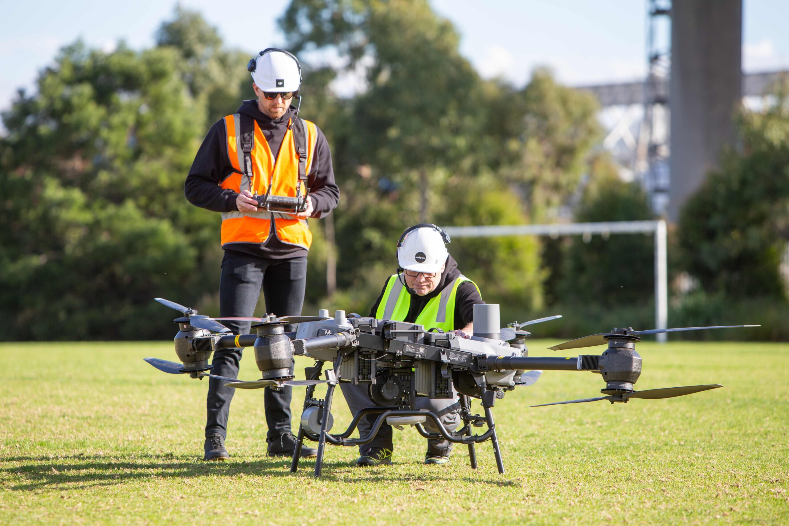 Drone Pilots inspecting large drones on the ground