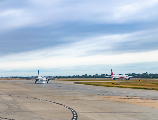 Two planes on airport tarmac.