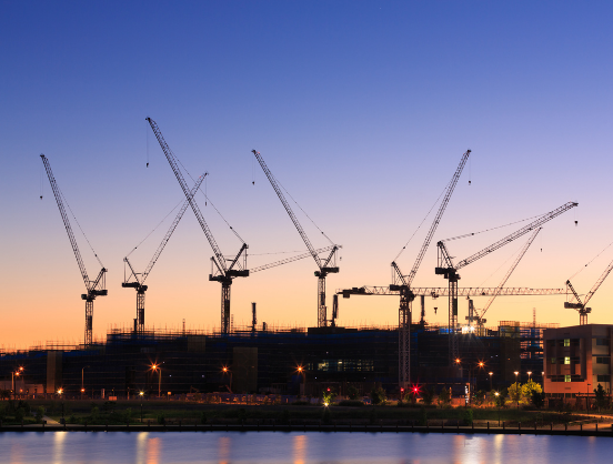 A series of cranes on a construction site.