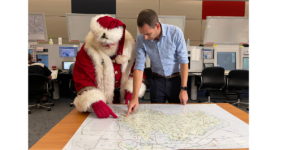 Santa and an Airservices team member check his flight path ahead of Operation Present Drop.