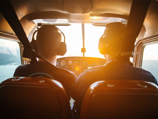 Two pilots in a recreational aircraft.