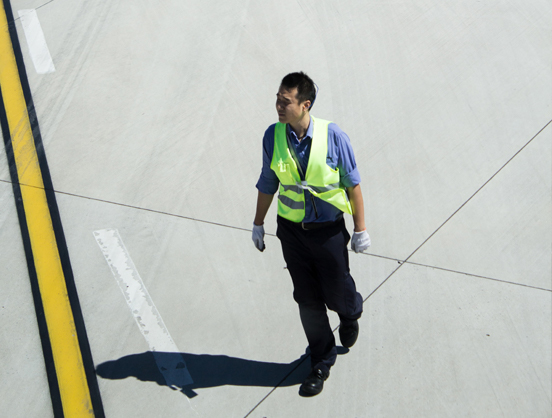 Airport staff member in high-vis on tarmac