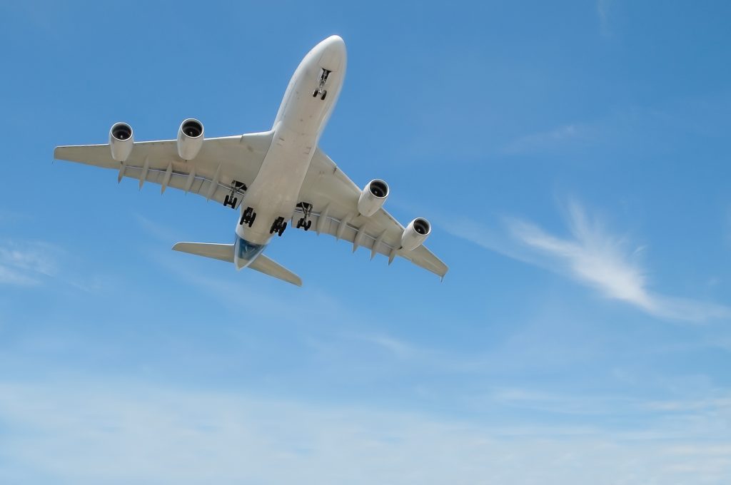 large jet aircraft in a blue cloudy sky